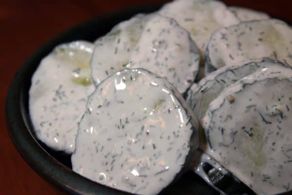 bowl of cucumber salad with creamy dill dressing