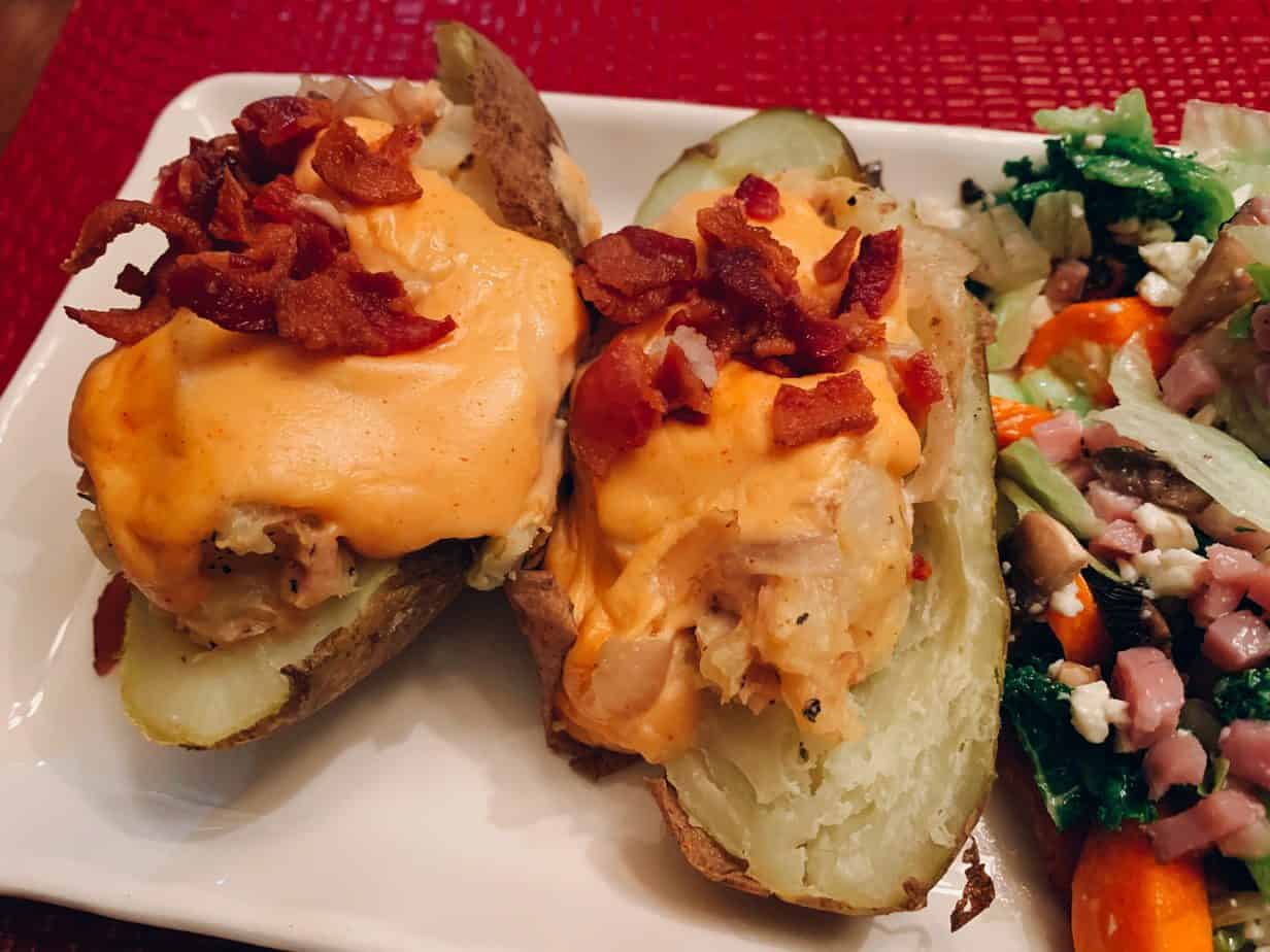 Two twice baked potatoes with cheese sauce