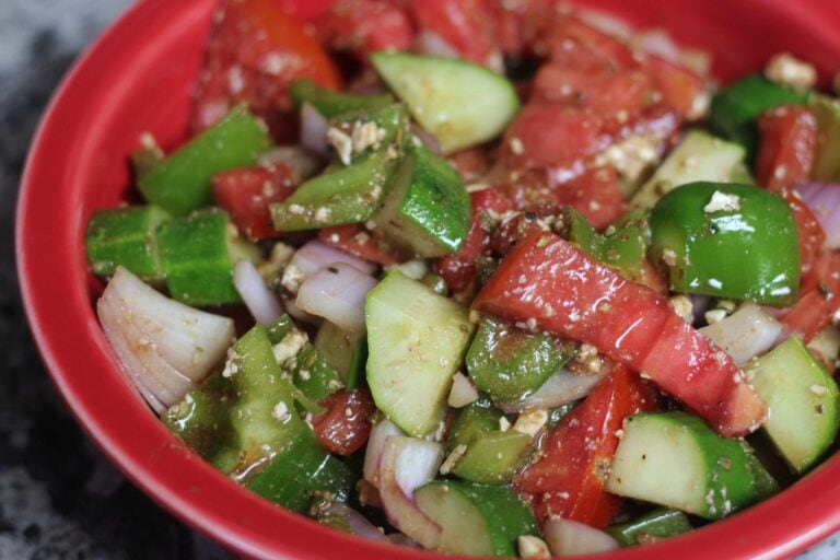 Greek salad in a red bowl