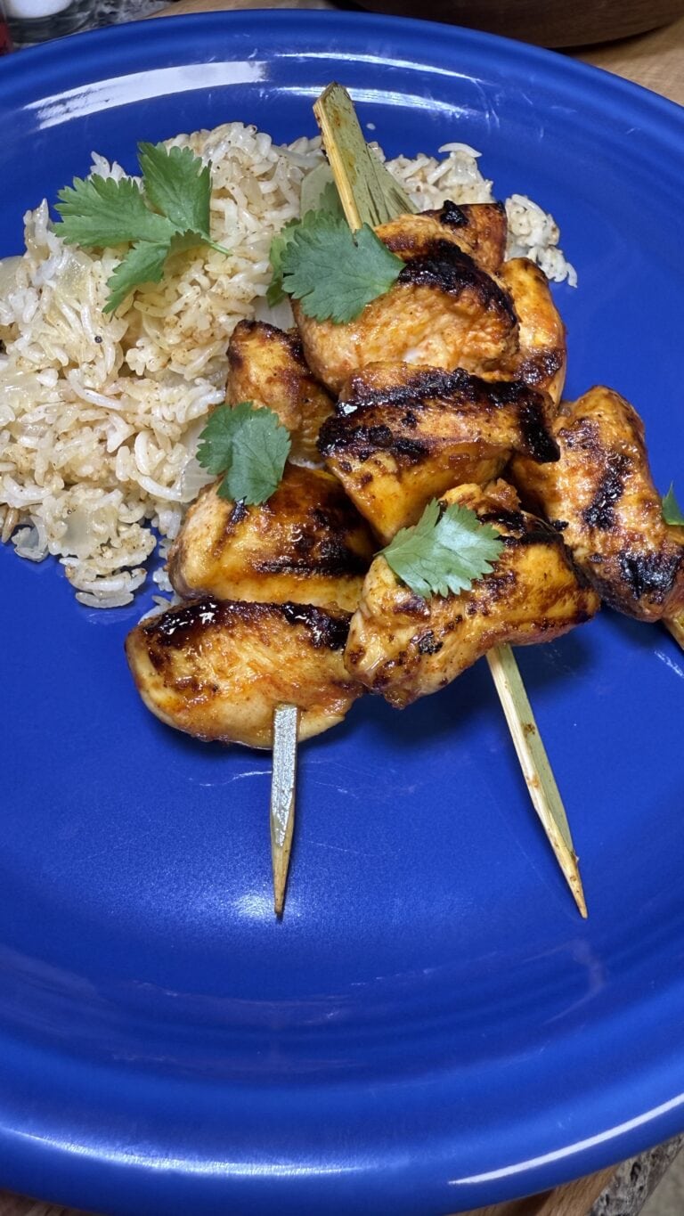 lemon garlic chicken kebabs on a blue plate